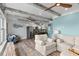 Spacious living room with a stylish kitchen featuring stainless steel appliances and a wooden dining table at 4939 Floramar Ter # 208, New Port Richey, FL 34652