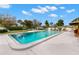 Outdoor swimming pool with ample seating and lush landscaping at 4939 Floramar Ter # 208, New Port Richey, FL 34652