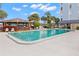 Exterior shot of a clean community pool with a gazebo and seating areas at 4939 Floramar Ter # 208, New Port Richey, FL 34652