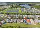 Scenic aerial view of a residential community with serene lakes, lush landscaping, and well-maintained homes at 5124 Clover Mist Dr, Apollo Beach, FL 33572