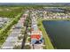 Beautiful aerial view of a residential community with homes lining a serene lake, offering picturesque waterfront living at 5124 Clover Mist Dr, Apollo Beach, FL 33572