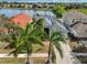 Aerial view of home featuring a well-maintained lawn and landscaping, solar panels, and a tranquil lake view at 5124 Clover Mist Dr, Apollo Beach, FL 33572