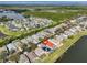 Beautiful aerial view of a lakeside community showcasing a home with solar panels and a pool at 5124 Clover Mist Dr, Apollo Beach, FL 33572