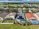 Aerial view of backyard featuring solar panels, a screened enclosure, and a tranquil lake, offering a private oasis at 5124 Clover Mist Dr, Apollo Beach, FL 33572
