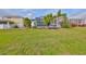Lush backyard featuring a screened patio and beautifully landscaped area, perfect for outdoor living and entertainment at 5124 Clover Mist Dr, Apollo Beach, FL 33572