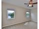 Spacious bedroom features plush carpet, ceiling fan, and windows with views of the lake at 5124 Clover Mist Dr, Apollo Beach, FL 33572