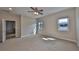 Large main bedroom features plush carpet, a ceiling fan, two windows and an en-suite bathroom at 5124 Clover Mist Dr, Apollo Beach, FL 33572