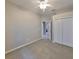 Carpeted bedroom with standard closet, ceiling fan, and open doorway to the tiled hallway at 5124 Clover Mist Dr, Apollo Beach, FL 33572