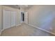 Carpeted bedroom with standard closet, ceiling fan, and open doorway to the tiled hallway at 5124 Clover Mist Dr, Apollo Beach, FL 33572