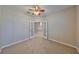 Inviting bedroom with french doors, neutral paint, carpet, and a ceiling fan at 5124 Clover Mist Dr, Apollo Beach, FL 33572