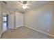 Carpeted bedroom with standard closet, ceiling fan, and open doorway to the tiled hallway at 5124 Clover Mist Dr, Apollo Beach, FL 33572