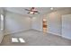 Bedroom with plush carpet, ceiling fan, and ensuite bath with dual sinks and granite counters at 5124 Clover Mist Dr, Apollo Beach, FL 33572