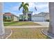 Charming home with well-maintained landscaping, palm trees, and an American flag at 5124 Clover Mist Dr, Apollo Beach, FL 33572