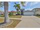 Charming home with well-maintained landscaping, palm trees, and an American flag at 5124 Clover Mist Dr, Apollo Beach, FL 33572