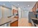 Updated kitchen features stainless appliances, bar counter, and wood flooring at 5124 Clover Mist Dr, Apollo Beach, FL 33572