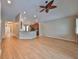 Open living room with wood floors, adjoining kitchen, and neutral color palette at 5124 Clover Mist Dr, Apollo Beach, FL 33572
