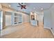 Spacious living area with hardwood floors and view to the modern kitchen at 5124 Clover Mist Dr, Apollo Beach, FL 33572