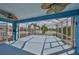 The screened patio has dual ceiling fans with a picturesque view of the nearby pond and landscaping at 5124 Clover Mist Dr, Apollo Beach, FL 33572