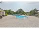 Outdoor pool area, surrounded by well-maintained patio, lounge chairs, and shade trees at 5124 Clover Mist Dr, Apollo Beach, FL 33572