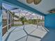 Relaxing screened patio with ceiling fans, overlooking a tranquil lake and lush landscaping for serene outdoor living at 5124 Clover Mist Dr, Apollo Beach, FL 33572