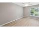 This vacant bedroom features modern laminate floors and a ceiling fan at 6141 Chesham Dr # 7, New Port Richey, FL 34653