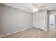 This vacant bedroom features modern laminate floors, fresh paint, and a closet at 6141 Chesham Dr # 7, New Port Richey, FL 34653