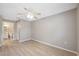 This vacant bedroom features modern laminate floors and an ensuite bathroom at 6141 Chesham Dr # 7, New Port Richey, FL 34653