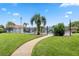 Fenced community pool with a sidewalk and grassy surroundings at 6141 Chesham Dr # 7, New Port Richey, FL 34653