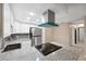 Well-lit kitchen featuring granite countertops, stainless steel appliances, and ample cabinet space at 6141 Chesham Dr # 7, New Port Richey, FL 34653