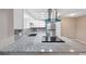 Modern kitchen with granite counters, stainless steel appliances, and stylish backsplash at 6141 Chesham Dr # 7, New Port Richey, FL 34653