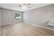 Bright and airy living room featuring light-colored walls and wood-look flooring at 6141 Chesham Dr # 7, New Port Richey, FL 34653