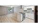 Open-concept living space seamlessly connecting to a modern kitchen with sleek appliances at 6141 Chesham Dr # 7, New Port Richey, FL 34653