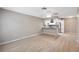 Spacious living room featuring light wood floors and adjoining kitchen at 6141 Chesham Dr # 7, New Port Richey, FL 34653