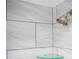 Close up of tiled shower featuring glass shelving and modern fixtures at 6141 Chesham Dr # 7, New Port Richey, FL 34653