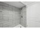 Contemporary tiled shower featuring glass shelving and modern fixtures at 6141 Chesham Dr # 7, New Port Richey, FL 34653