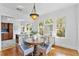 Bright dining space with hardwood floors, a round table, and an open view into the modern kitchen at 6705 N Navin Ave, Tampa, FL 33604