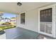 Welcoming front porch featuring a screen door, painted wood floors, and classic details at 6705 N Navin Ave, Tampa, FL 33604