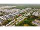 Expansive aerial view of a community featuring homes, RV park, and green spaces near a waterway at 6802 Sandra Dr, Port Richey, FL 34668