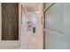 Hallway featuring kitchen, bathroom doorway, and brown barn-style closet doors at 7701 Starkey Rd # 208, Seminole, FL 33777