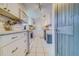 Bright kitchen with white cabinets, stainless steel appliances, and tile flooring at 7701 Starkey Rd # 208, Seminole, FL 33777