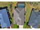 Aerial view showcases a home with a screened-in pool, surrounded by lush greenery at 10105 Holly Berry Dr, Weeki Wachee, FL 34613