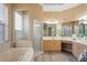 Elegant bathroom featuring a separate tub and shower, complemented by decorative wallpaper at 10105 Holly Berry Dr, Weeki Wachee, FL 34613