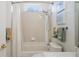 Clean bathroom featuring a shower/tub combo, decorative tile, and seashell accents at 10105 Holly Berry Dr, Weeki Wachee, FL 34613