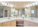 Spacious bathroom featuring dual sinks, a large mirror, and ample lighting for a luxurious feel at 10105 Holly Berry Dr, Weeki Wachee, FL 34613