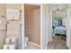 Bathroom view showing the toilet, towel rack and access into the nearby bedroom with access to the backyard at 10105 Holly Berry Dr, Weeki Wachee, FL 34613