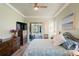 Well-lit bedroom with a queen bed, ensuite sliding glass door to screened patio, and backyard pool at 10105 Holly Berry Dr, Weeki Wachee, FL 34613