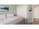 Calming bedroom with a comfy bed, white closet doors, and soft green walls at 10105 Holly Berry Dr, Weeki Wachee, FL 34613