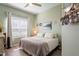 Cozy bedroom with soft green walls, a comfortable bed, and ample natural light at 10105 Holly Berry Dr, Weeki Wachee, FL 34613