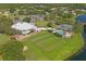 Aerial view of the clubhouse featuring a swimming pool, tennis courts, and parking at 10105 Holly Berry Dr, Weeki Wachee, FL 34613