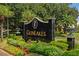 Elegant community sign, GLENLAKES, surrounded by manicured landscaping and lush greenery at 10105 Holly Berry Dr, Weeki Wachee, FL 34613